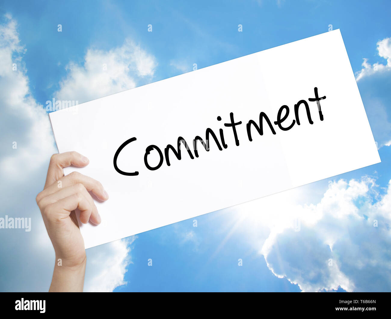 Commitment Sign on white paper. Man Hand Holding Paper with text ...