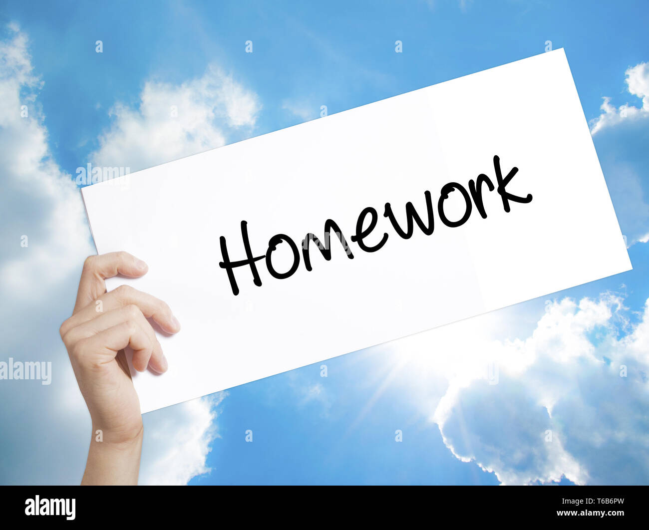 Homework Sign on white paper. Man Hand Holding Paper with text ...