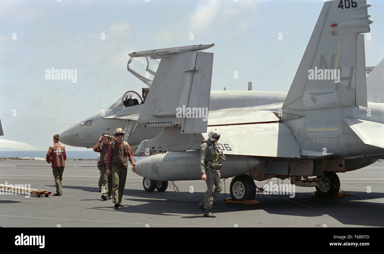 1st November 1993 Operation Continue Hope. On the flight deck of the U.S.Navy aircraft carrier USS Abraham Lincoln in the Indian Ocean, 50 miles off Mogadishu, Somalia: a pilot of an F/A-18 Hornet, checks his aircraft before take off. Stock Photo