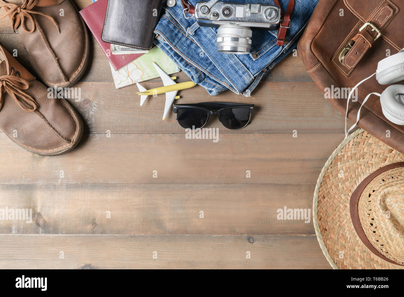 prepare backpack accessories and travel items on wood background with ...