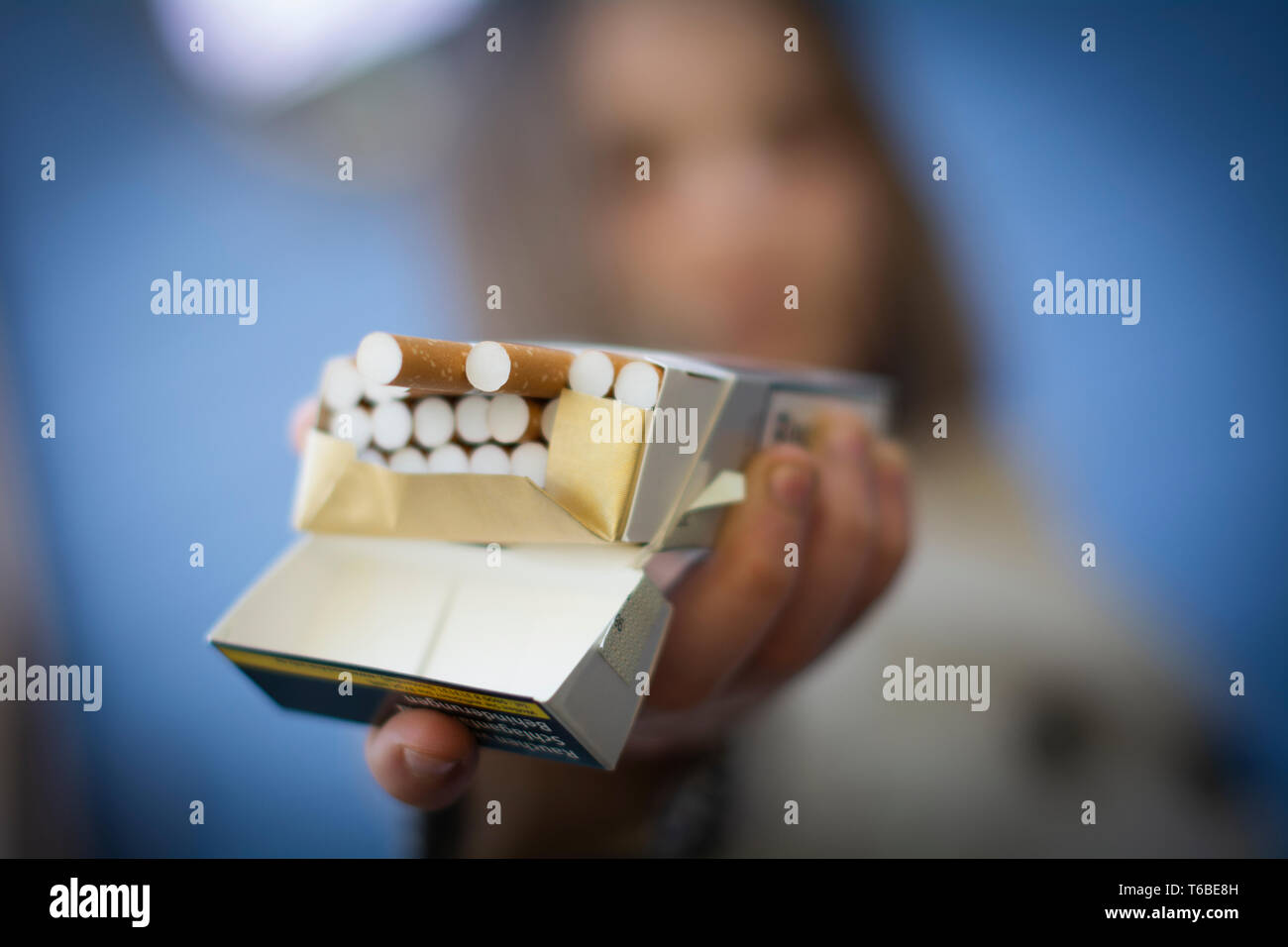 Young girl offers a cigarette. Stock Photo