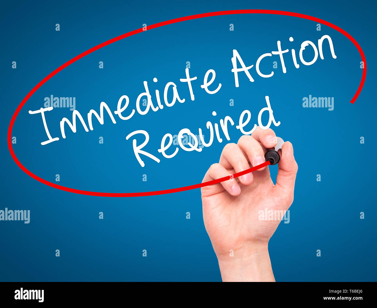 Man Hand writing Immediate Action Required with black marker on visual screen Stock Photo