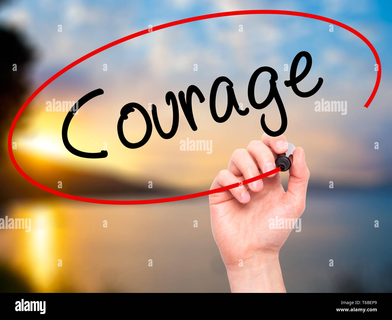 Man Hand writing Courage with black marker on visual screen Stock Photo ...