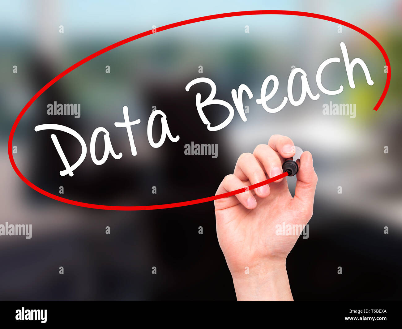 Man Hand writing Data Breach with black marker on visual screen Stock Photo
