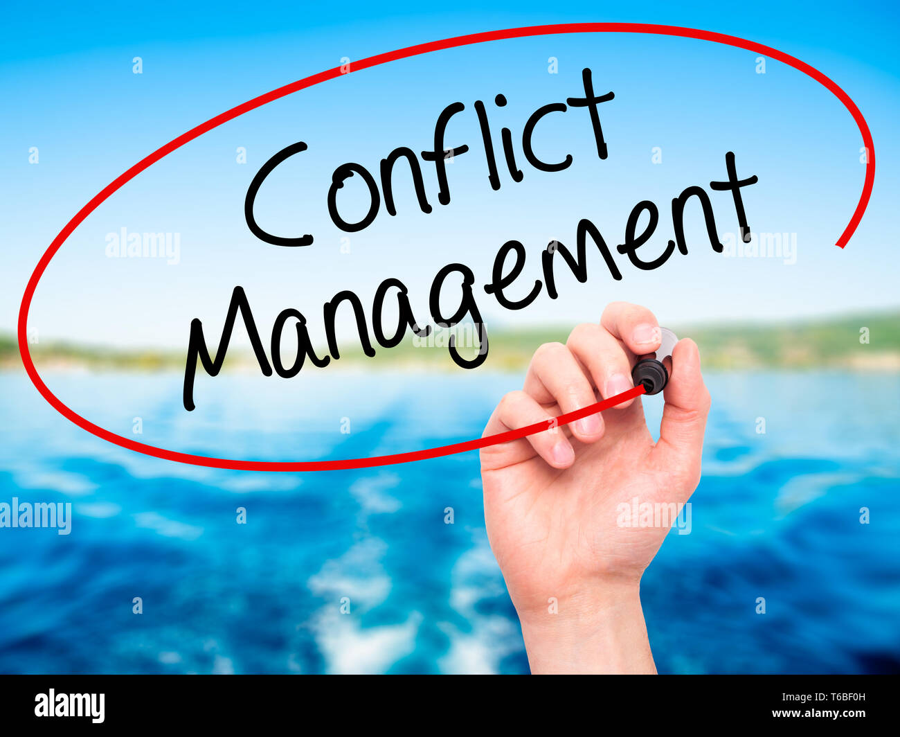 Man Hand writing Conflict Management with black marker on visual screen. Stock Photo