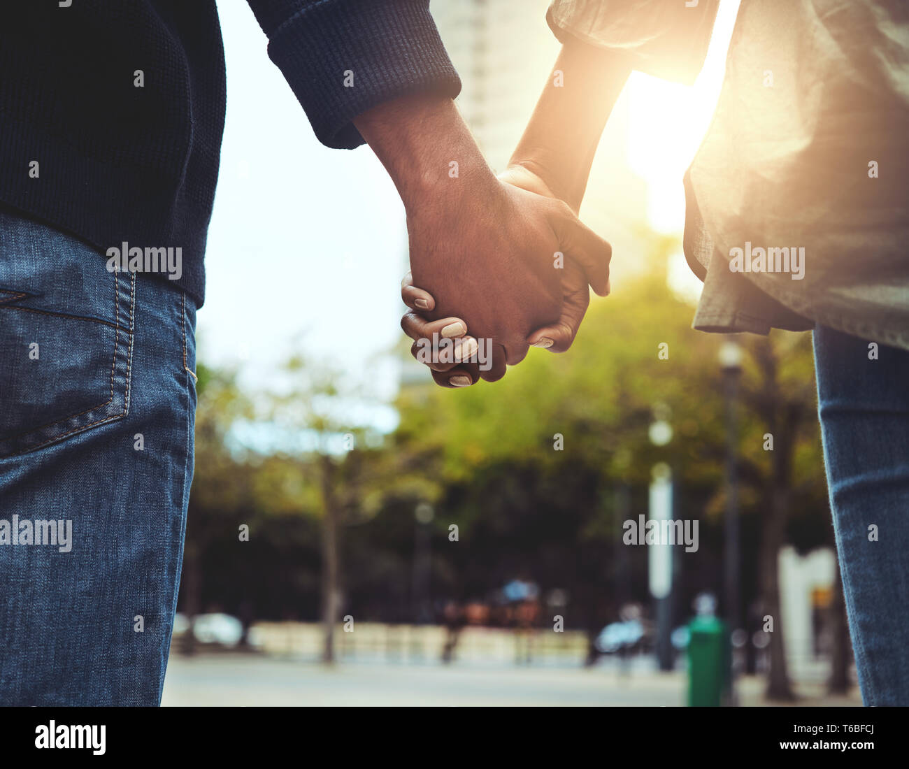 Couple holding the hands together at outdoors Stock Photo - Alamy