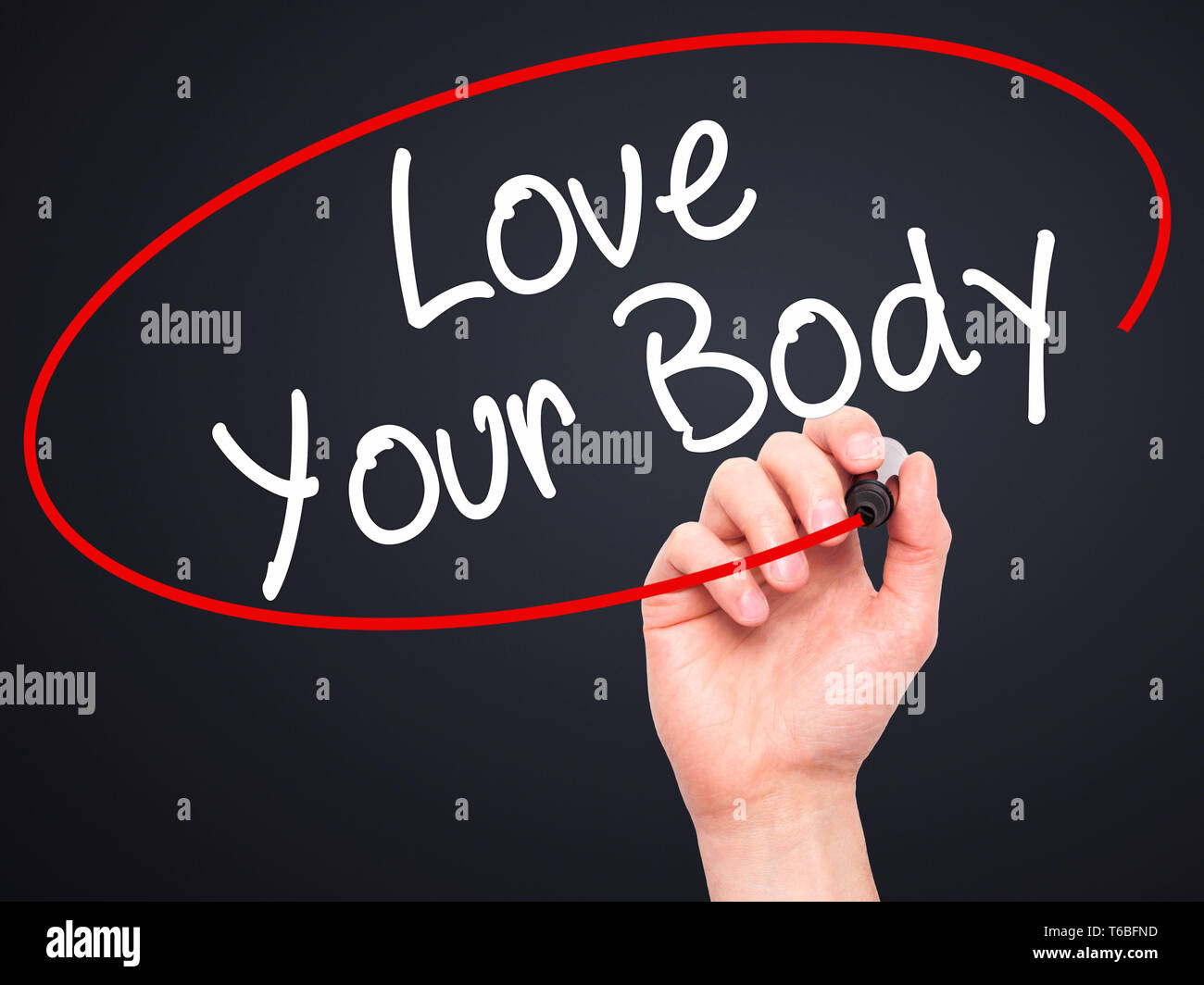 Man Hand writing Love Your Body with black marker on visual screen Stock Photo