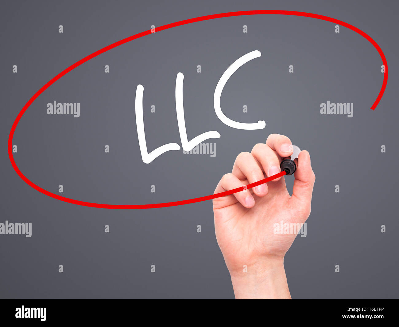 Man Hand writing LLC (Limited Liability Company) with black marker