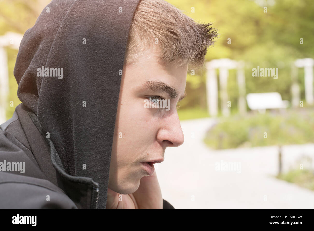 profile portrait of a young man with black hoodie Stock Photo