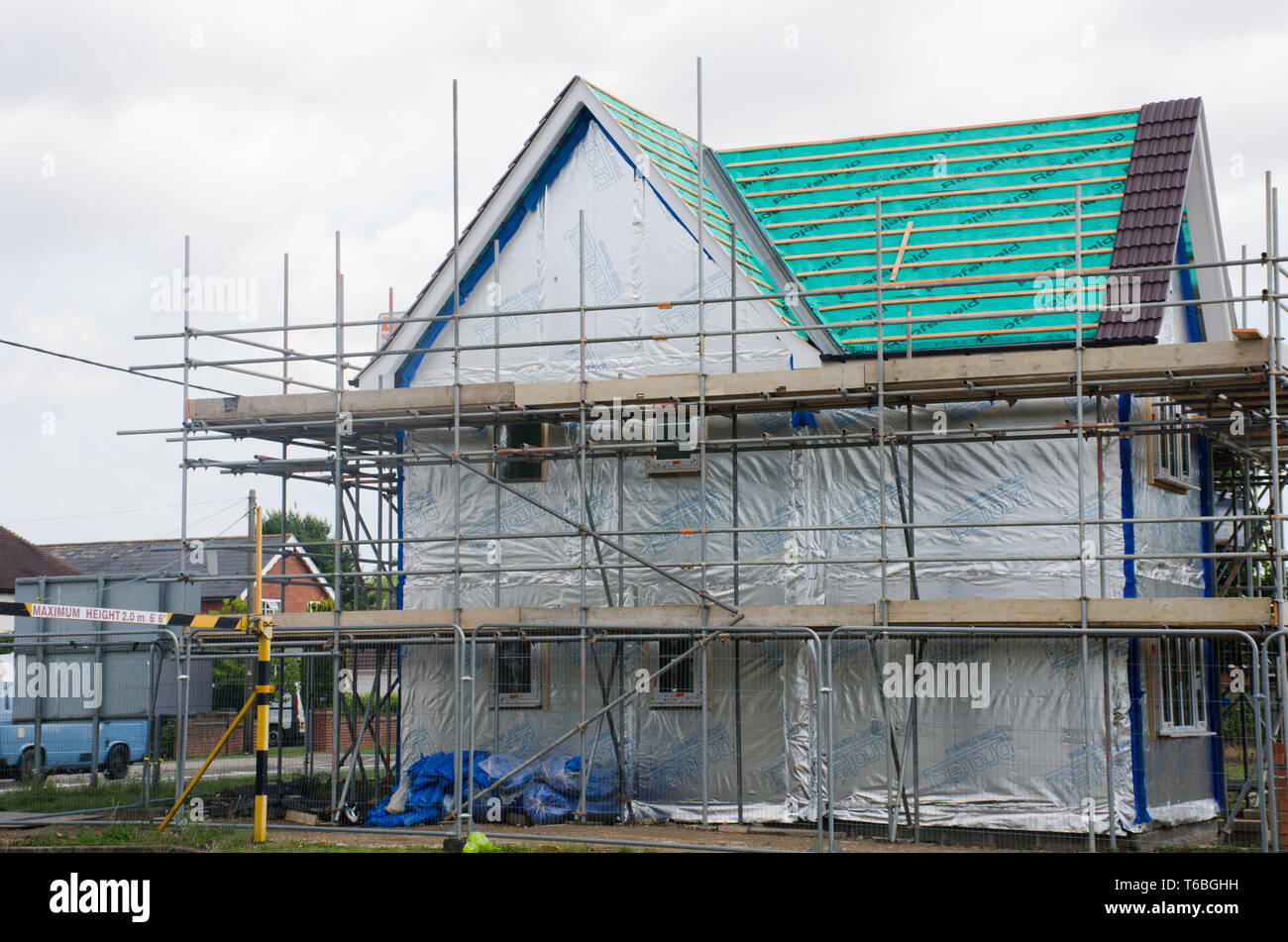 Scaffolding on side of new large house Stock Photo