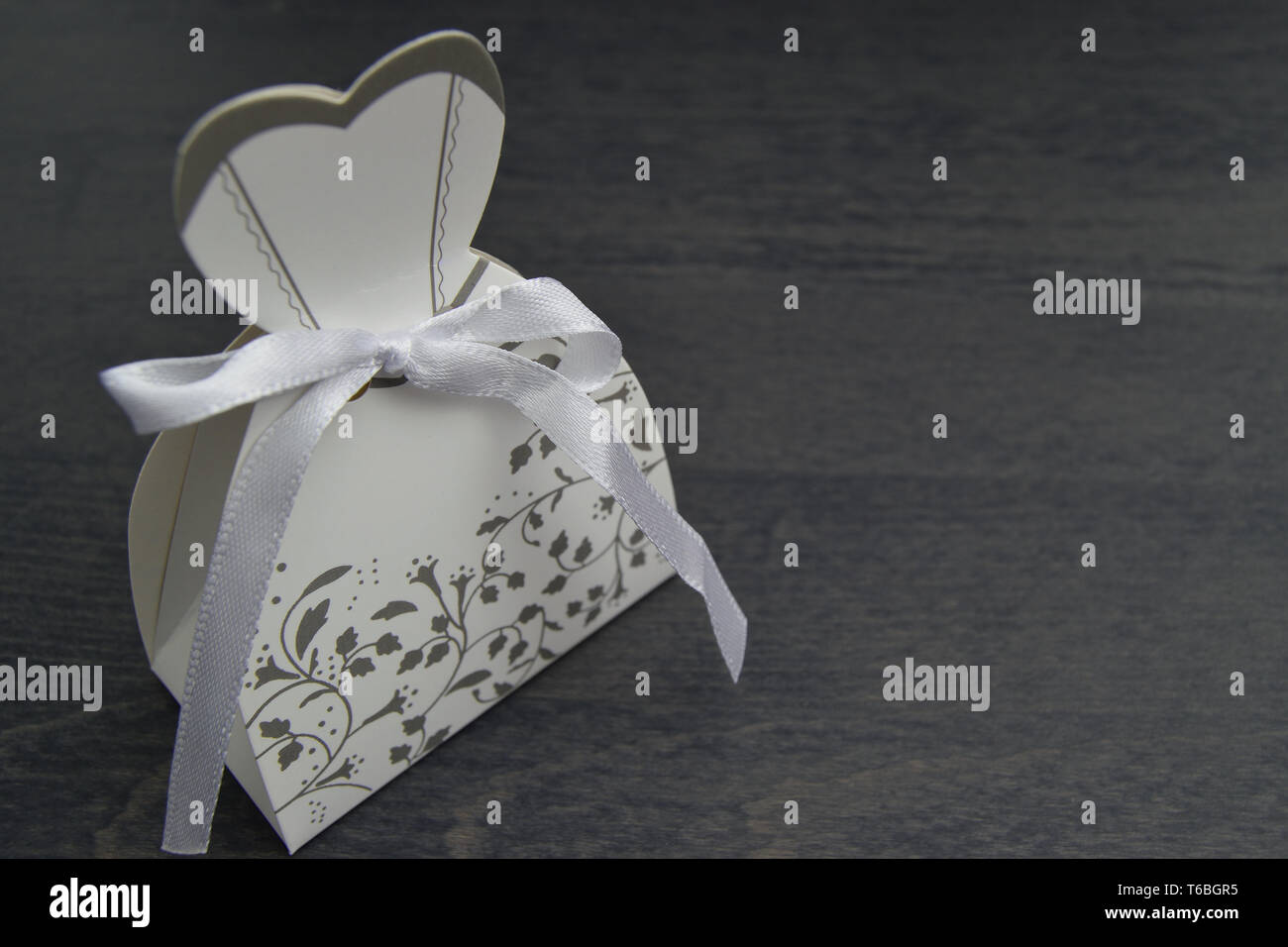 wedding dress shaped box with almond confetti inside Stock Photo Alamy