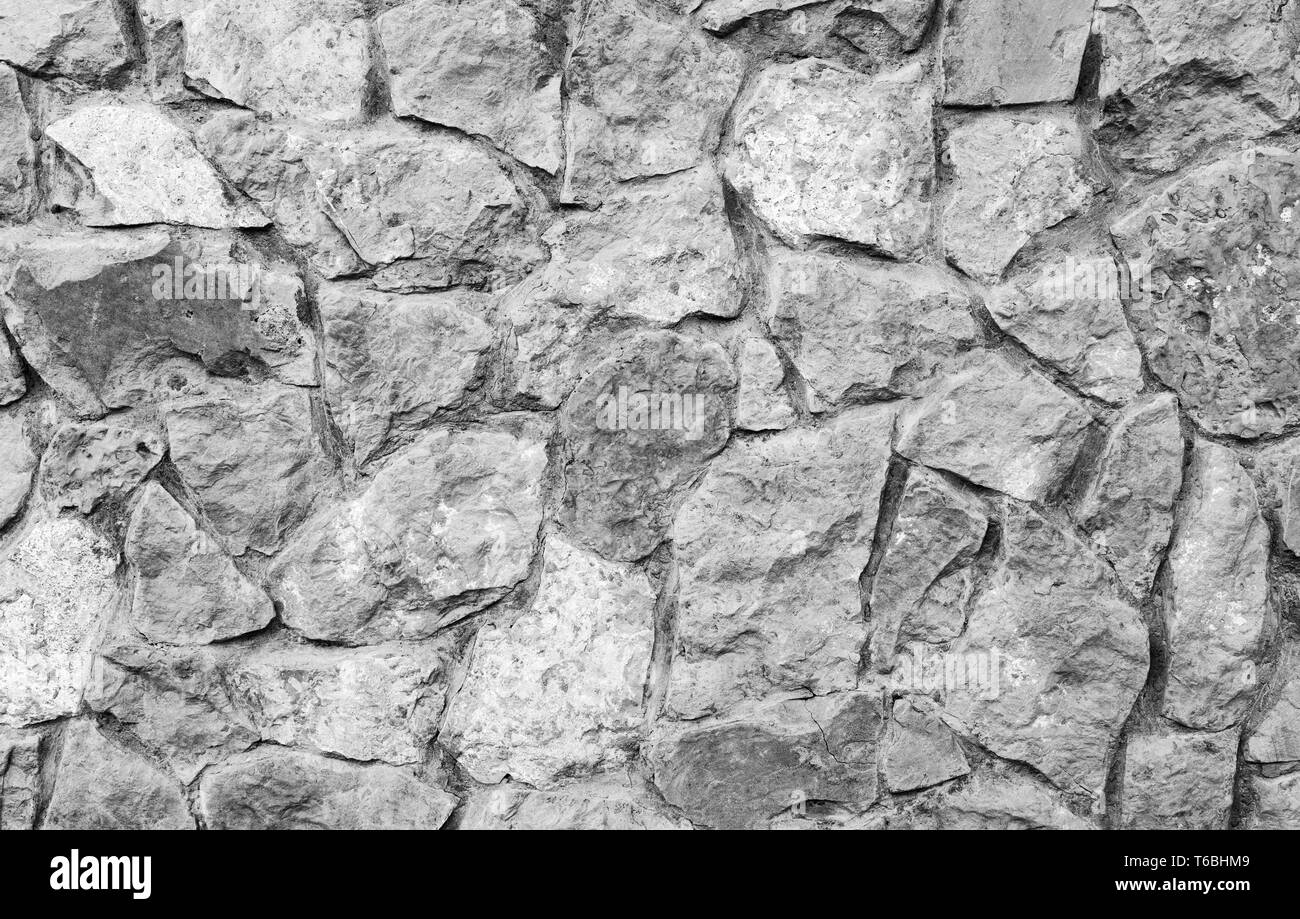 Grey stone wall background. Natural stone brick wall. Stock Photo