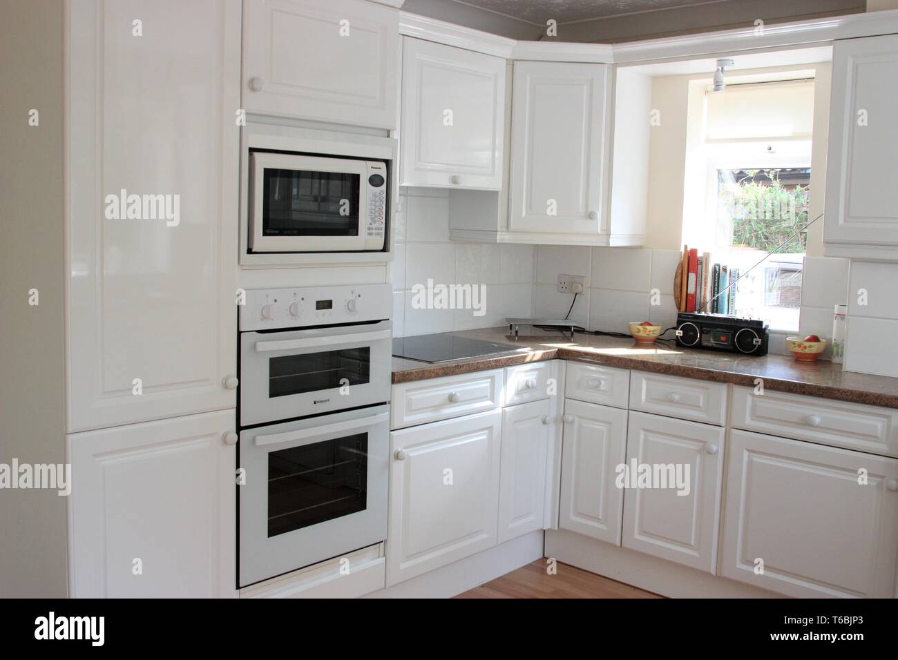 Modern kitchen interior with white units Stock Photo - Alamy