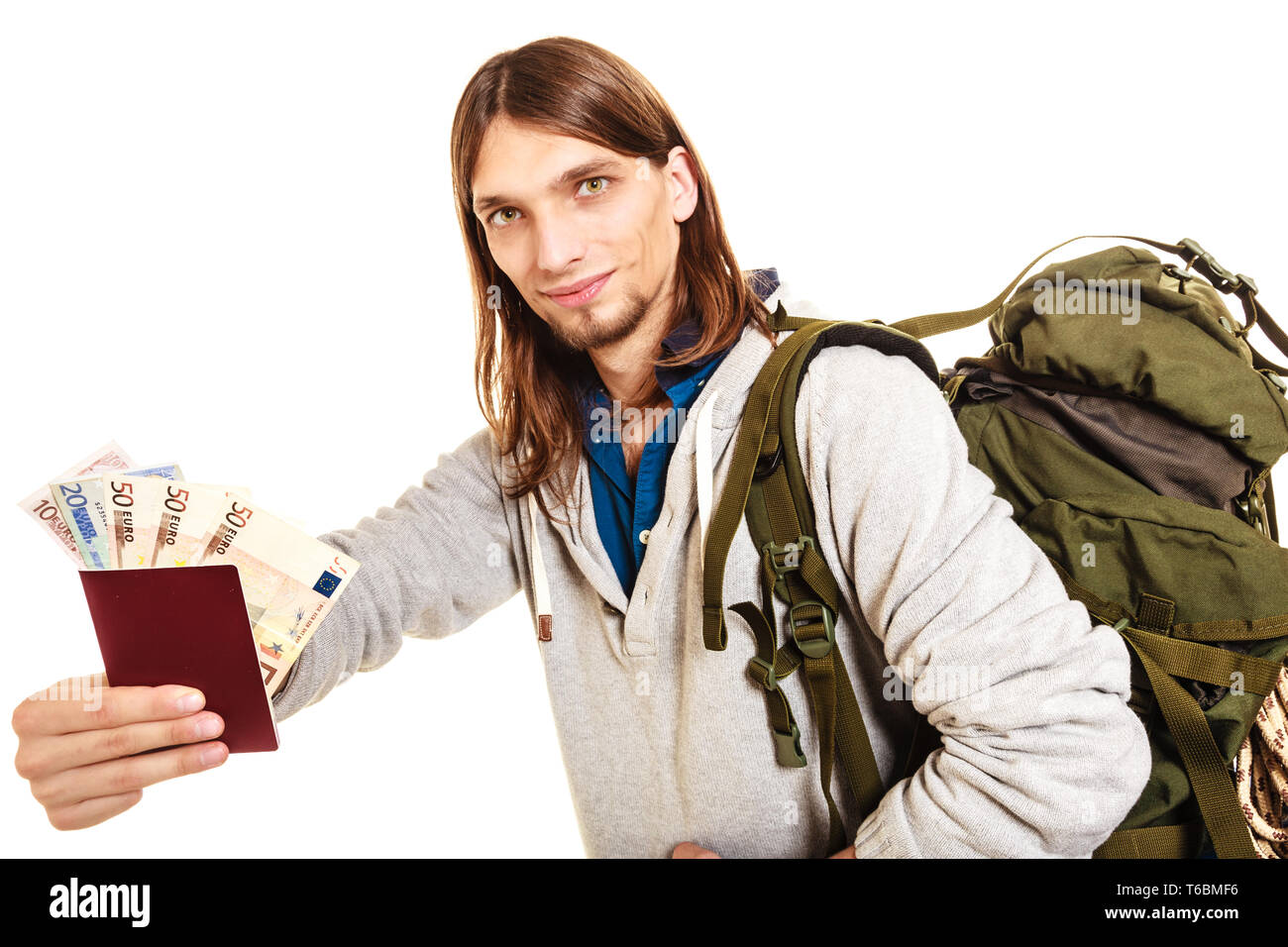 Man tourist backpacker holding passport full of money. Young guy hiker
