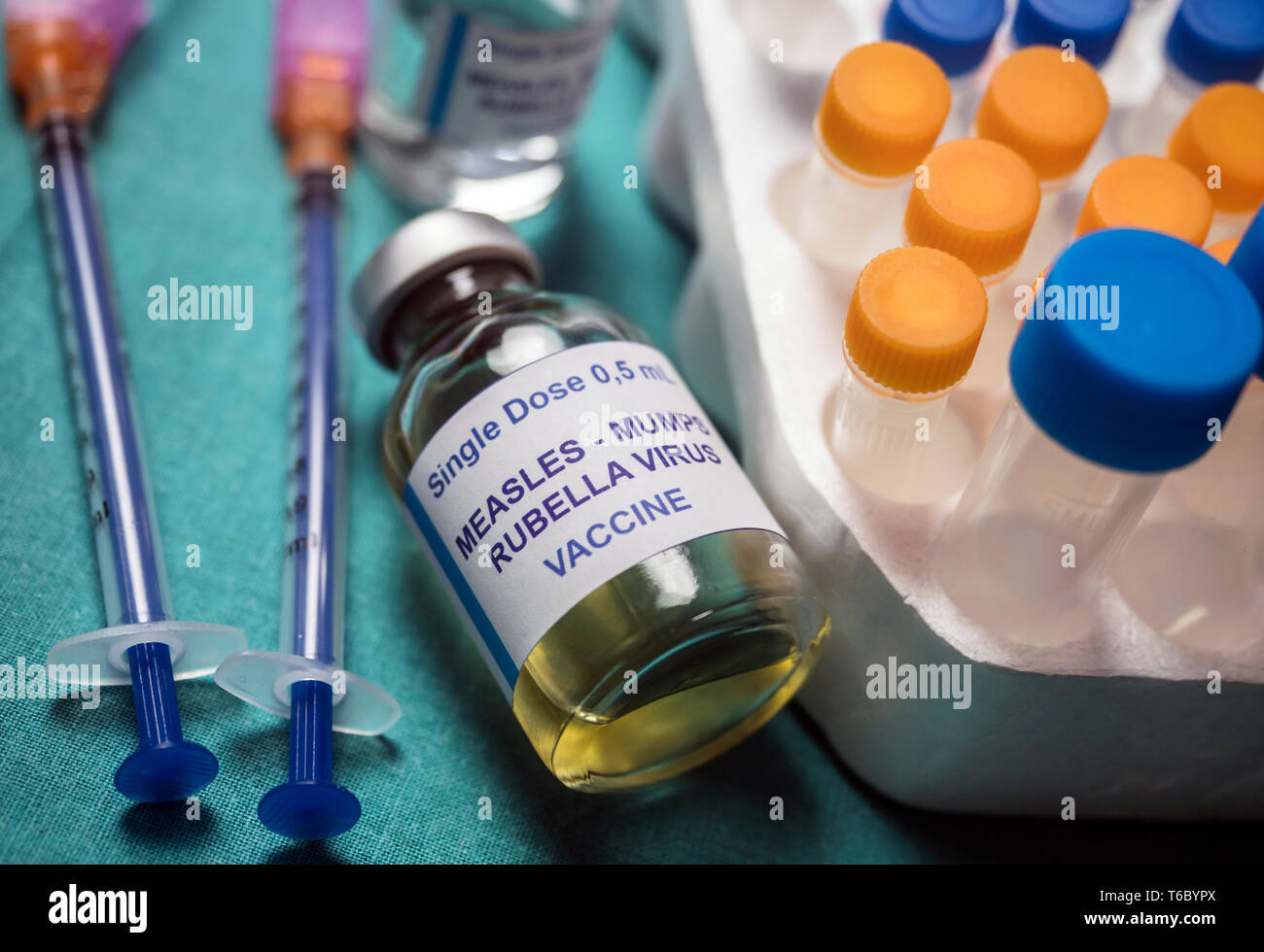 Different vials of triple viral vaccine of measles, rubella and mumps, known as MMR, conceptual image Stock Photo