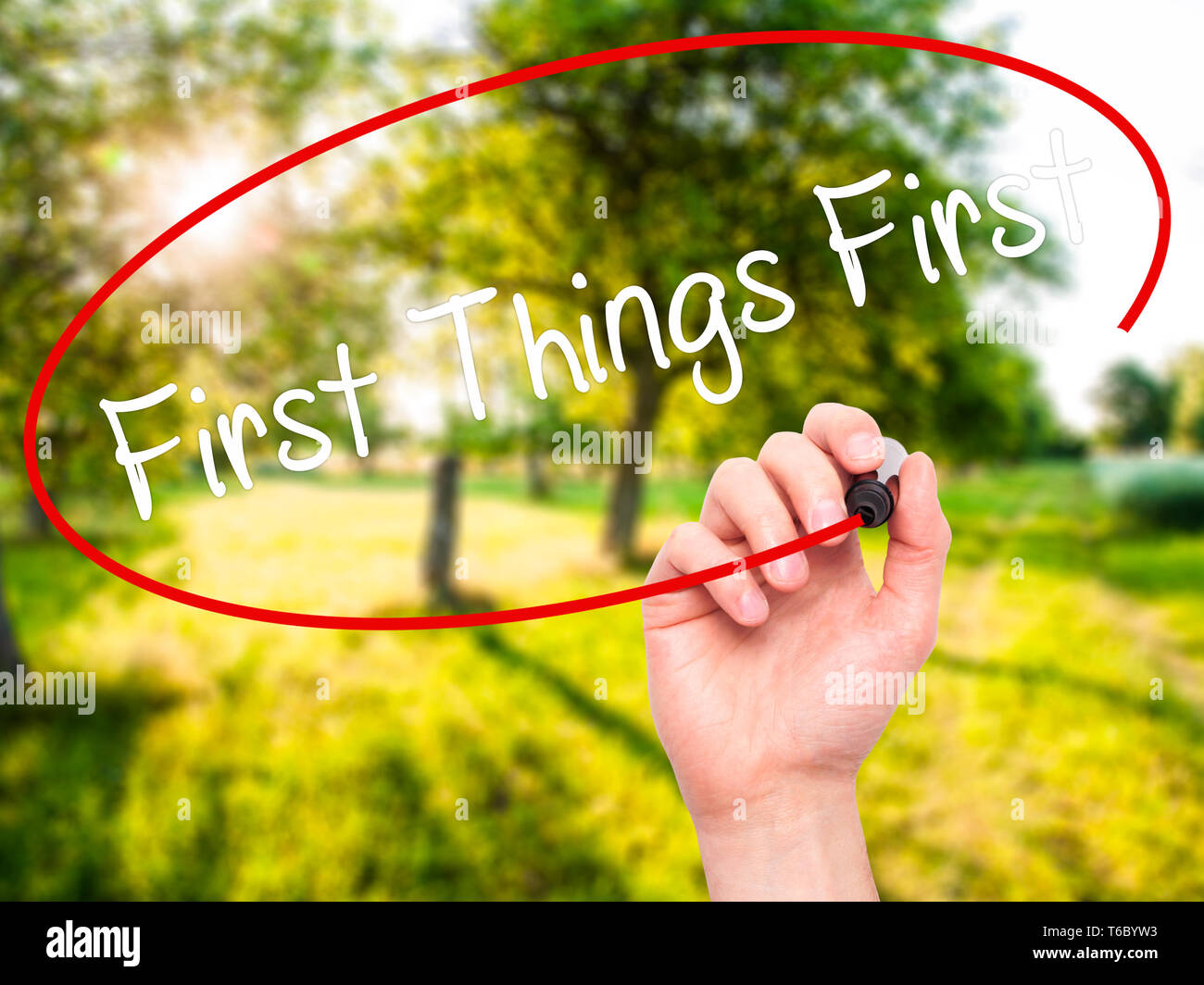 Man Hand writing First Things First with black marker on visual screen Stock Photo Alamy
