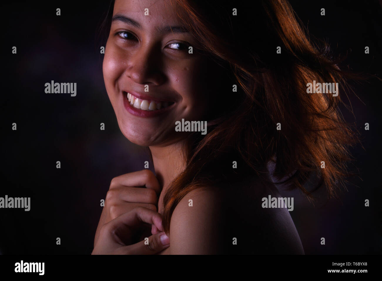 Smilling Woman Blonde Hair With Low Light Studio Stock Photo