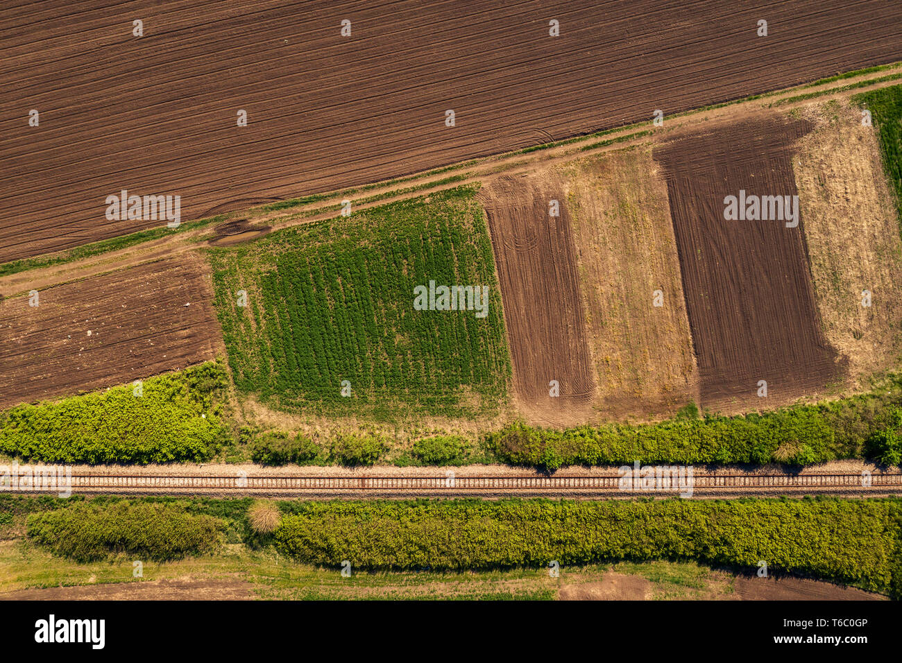 Aerial view of railway through countryside landscape, top down perspective from drone pov Stock Photo