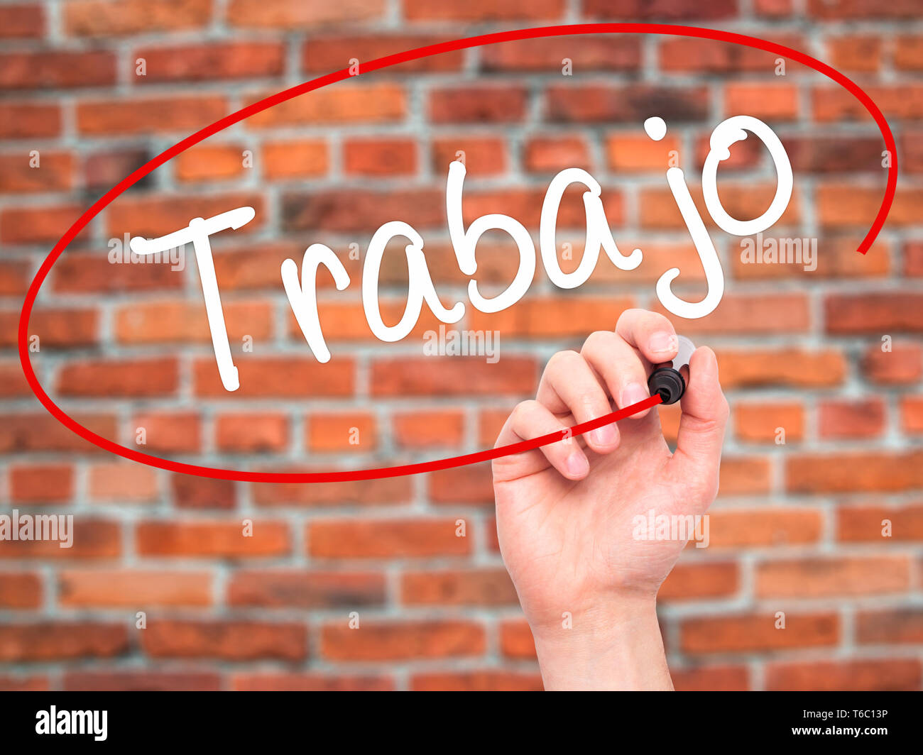 Man Hand writing Trabajo ( work in Spanish) with black marker on visual