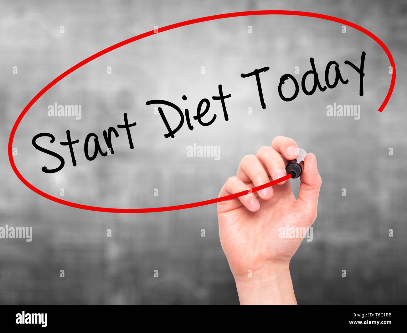 Man Hand writing Start Diet Today with black marker on visual screen Stock Photo