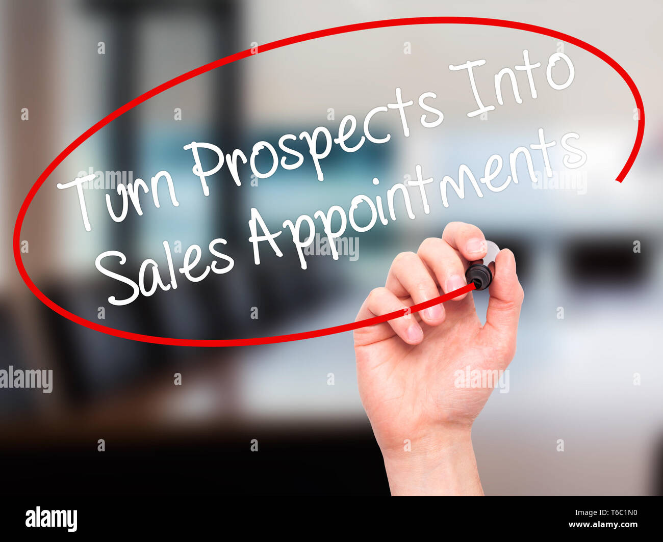 Man Hand writing Turn Prospects Into Sales Appointments with black marker on visual screen. Stock Photo