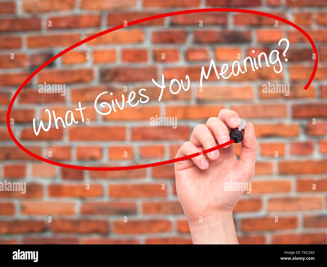 Man Hand writing What Gives You Meaning? with black marker on visual screen Stock Photo