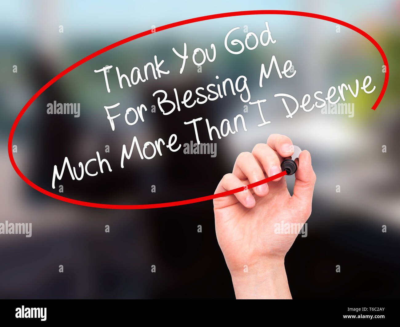 Man Hand writing Thank You God For Blessing Me Much More Than I Deserve with black marker on visual screen Stock Photo