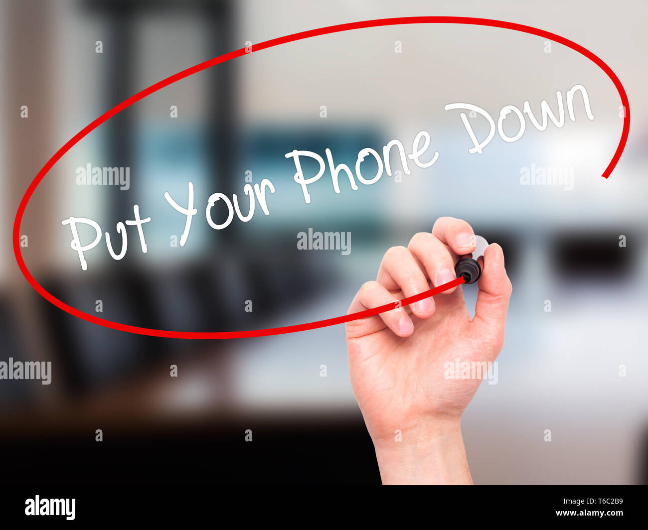 Man Hand writing Put Your Phone Down with black marker on visual screen Stock Photo