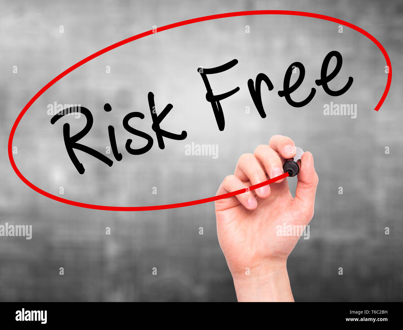 Man Hand writing Risk Free with black marker on visual screen Stock Photo