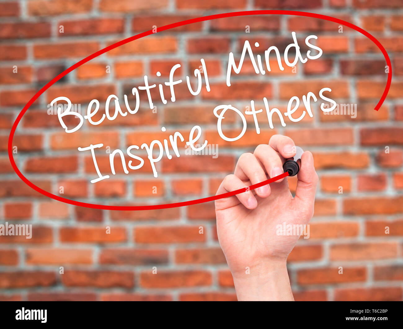 Man Hand writing Beautiful Minds Inspire Others with black marker on visual screen Stock Photo