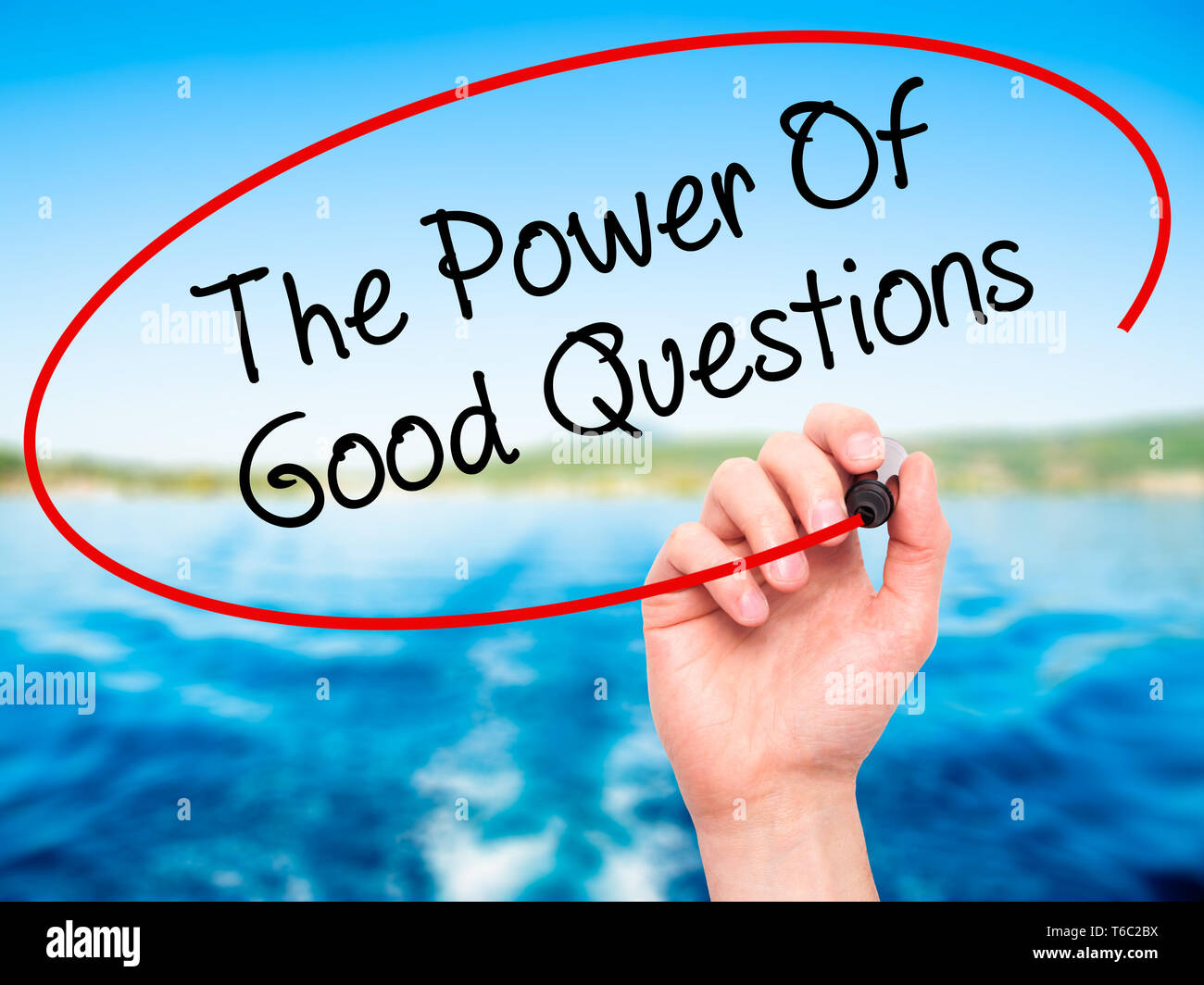 Man Hand writing The Power Of Good Questions with black marker on visual screen Stock Photo