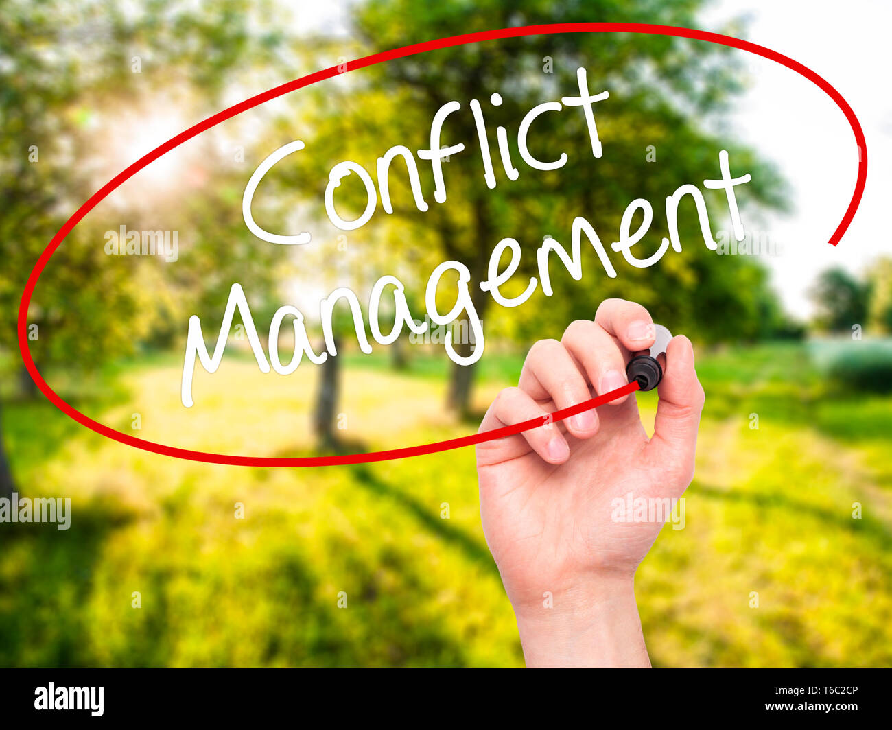 Man Hand writing Conflict Management with black marker on visual screen. Stock Photo