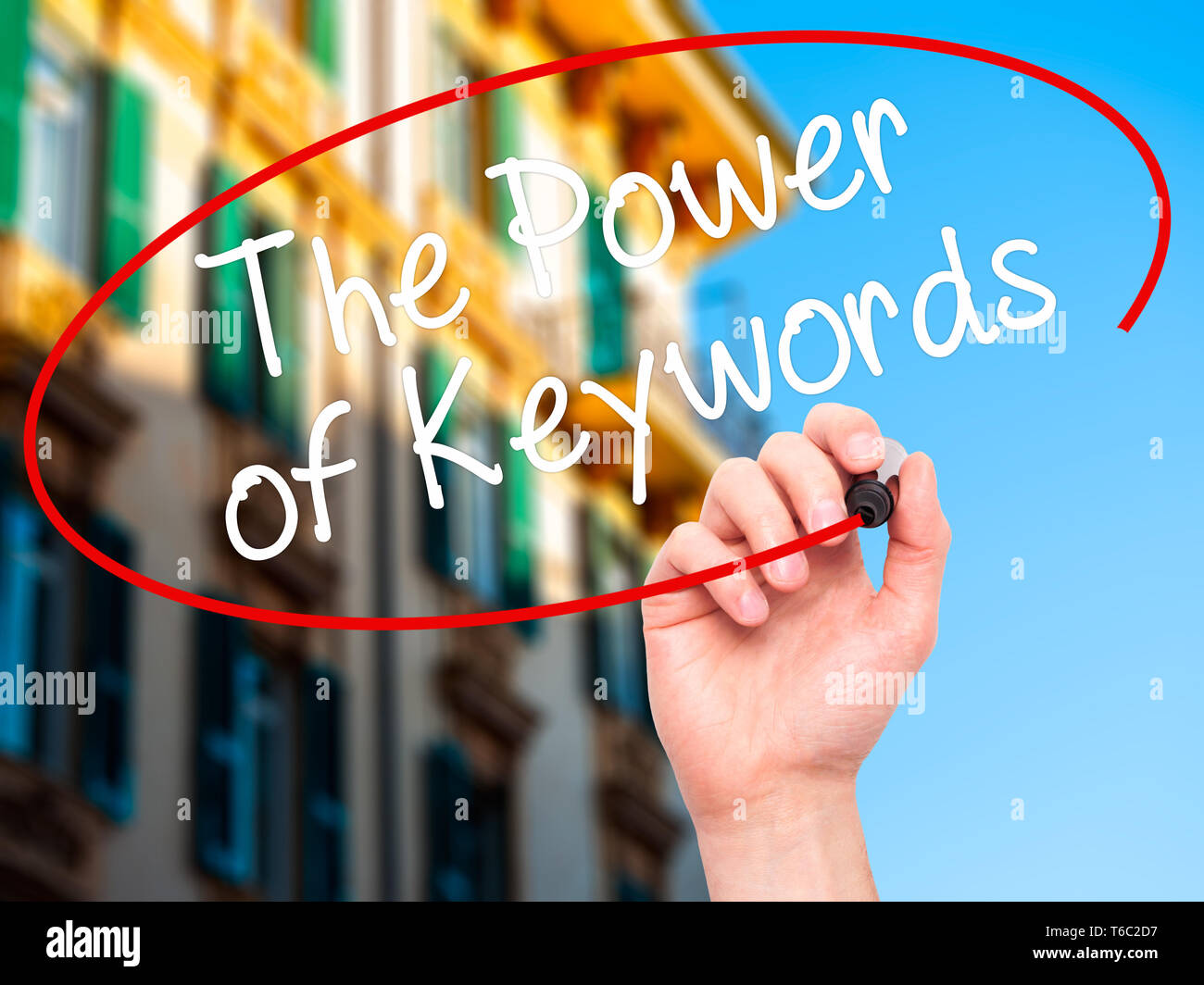 Man Hand writing The Power of Keywords with black marker on visual screen Stock Photo