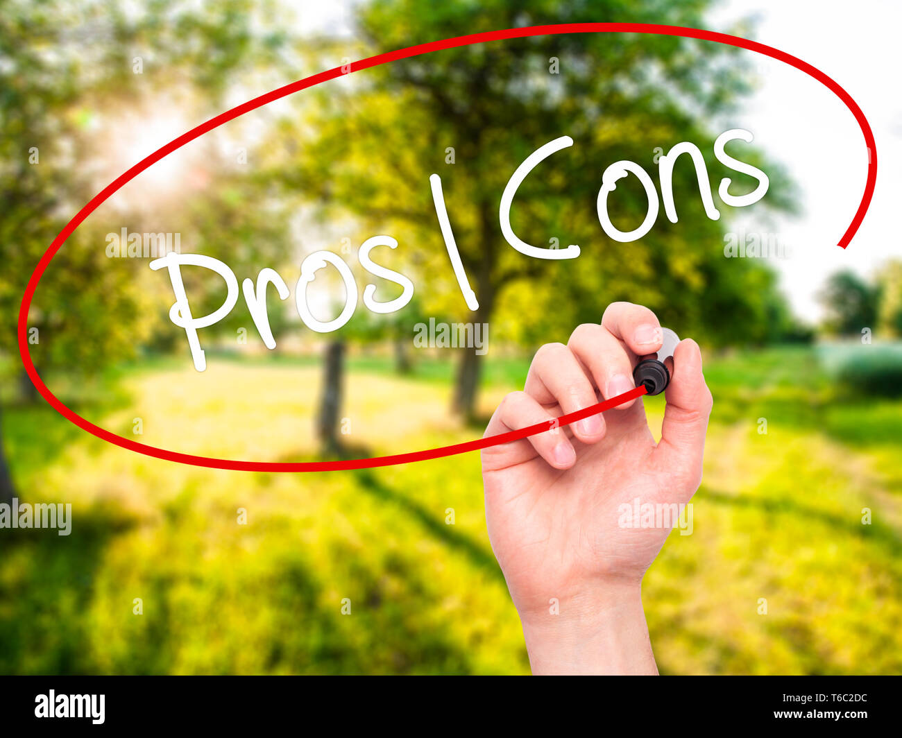 Man Hand writing Pros  Cons with black marker on visual screen Stock Photo
