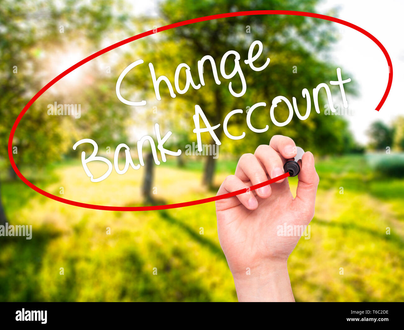 Man Hand writing Change Bank Account with black marker on visual screen Stock Photo
