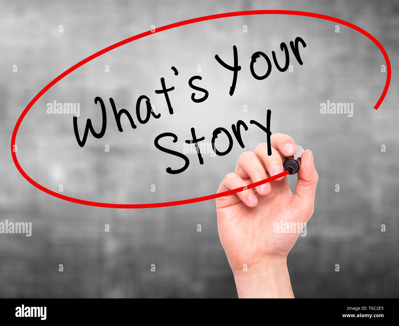 Man Hand writing What's Your Story with marker on transparent wipe board Stock Photo