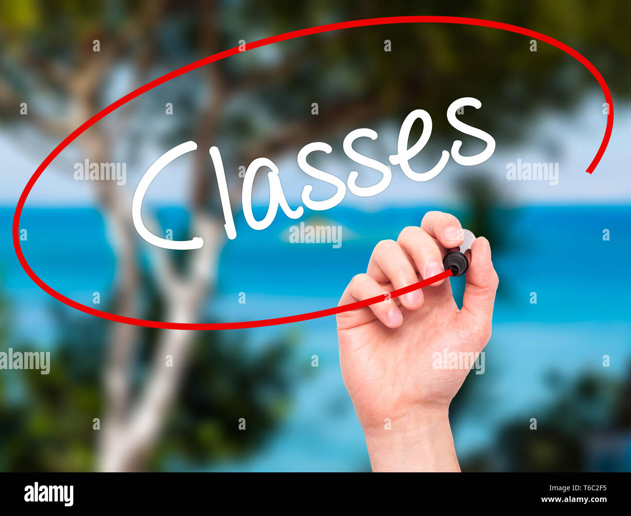 Man Hand writing Classes   with black marker on visual screen Stock Photo