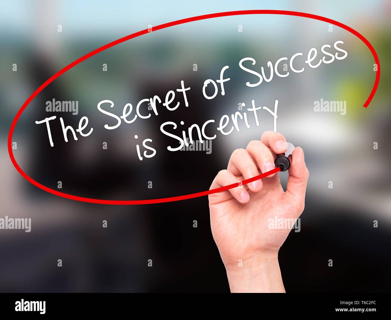 Man Hand writing The Secret of Success is Sincerity with black marker on visual screen. Stock Photo