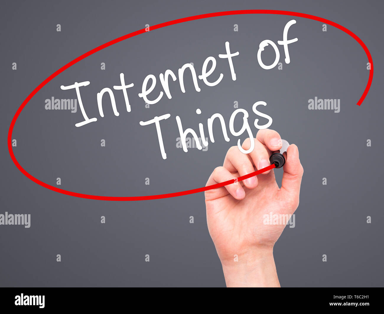 Man Hand writing Internet of Things with black marker on visual screen Stock Photo