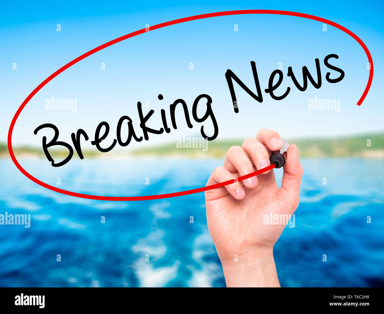 Man Hand writing Breaking News with black marker on visual screen Stock Photo