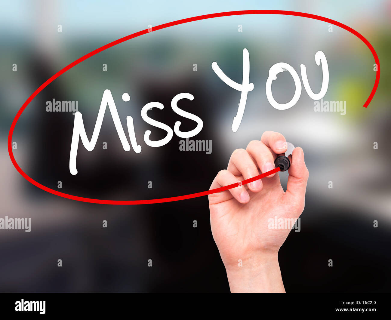 Man Hand writing Miss You with black marker on visual screen Stock Photo