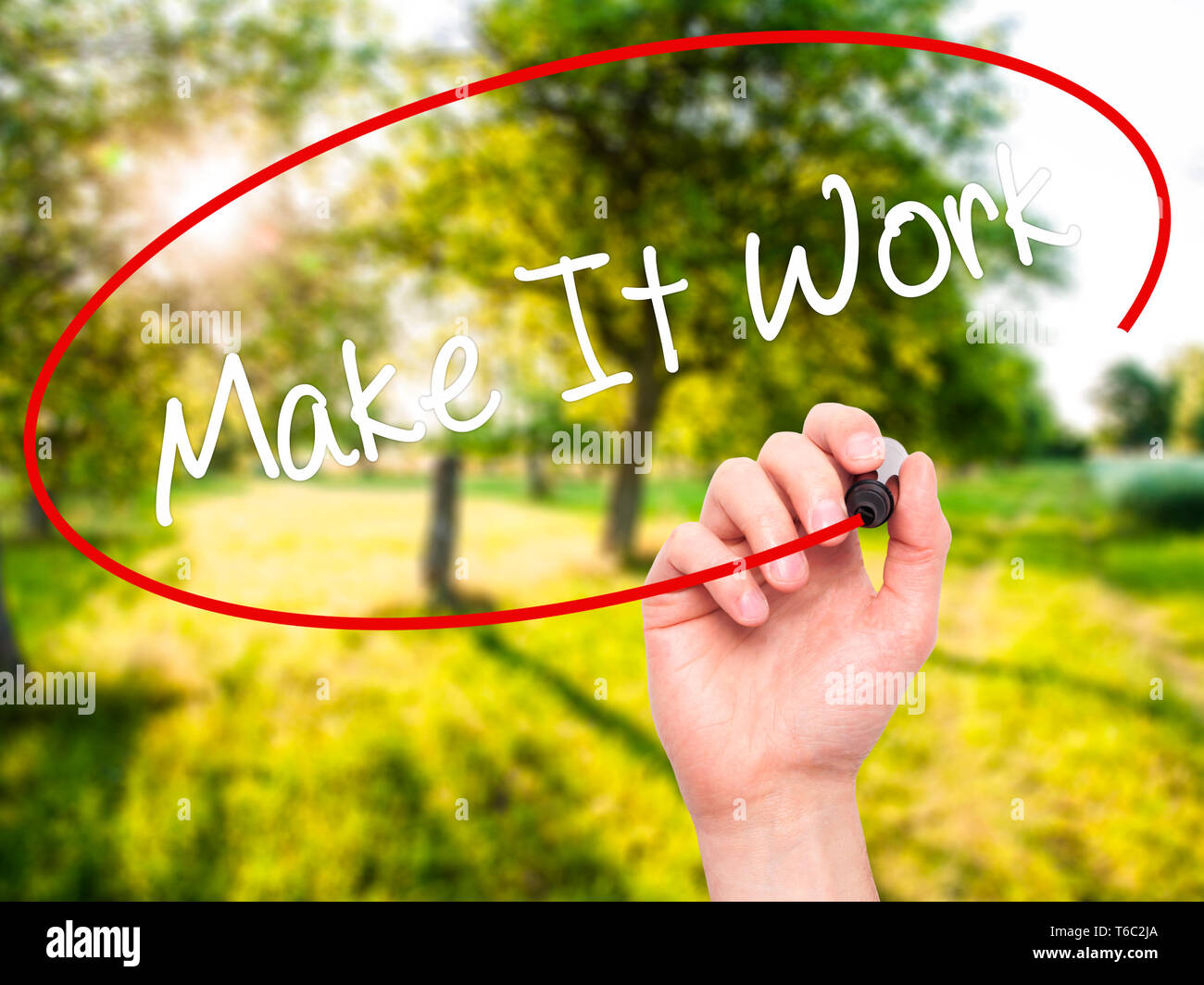 Man Hand writing Make It Work with black marker on visual screen Stock Photo