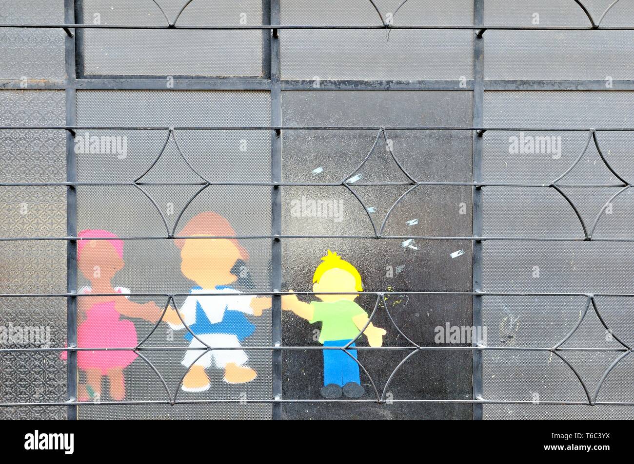 Child figures glued to the window Stock Photo