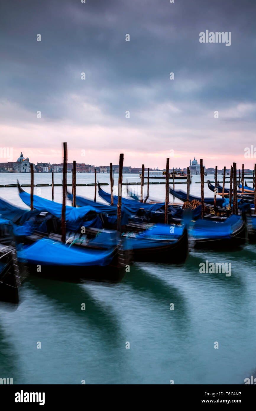 Gondolas moored at sunset, St. Mark's basin, Venice, Italy Stock Photo