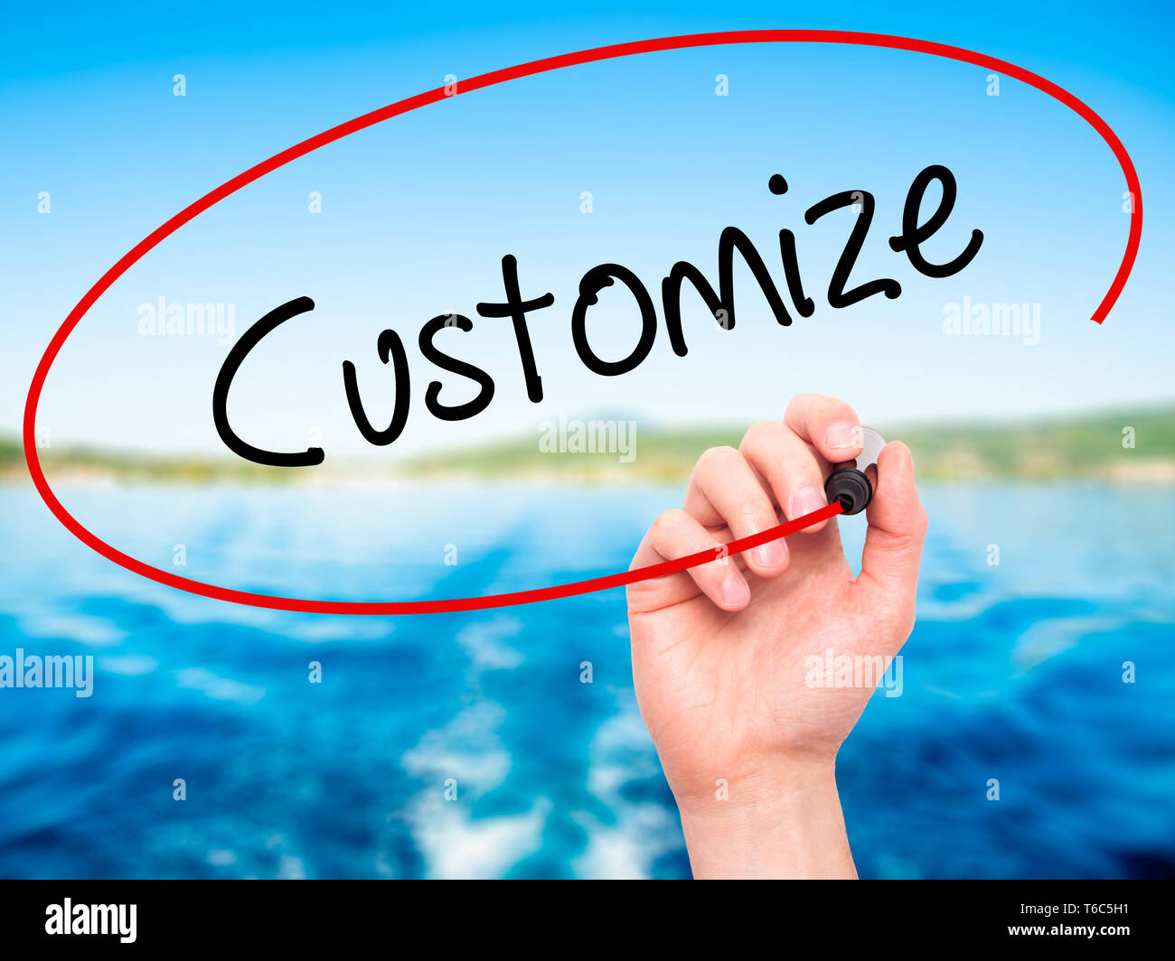 Man Hand writing  Customize with black marker on visual screen Stock Photo