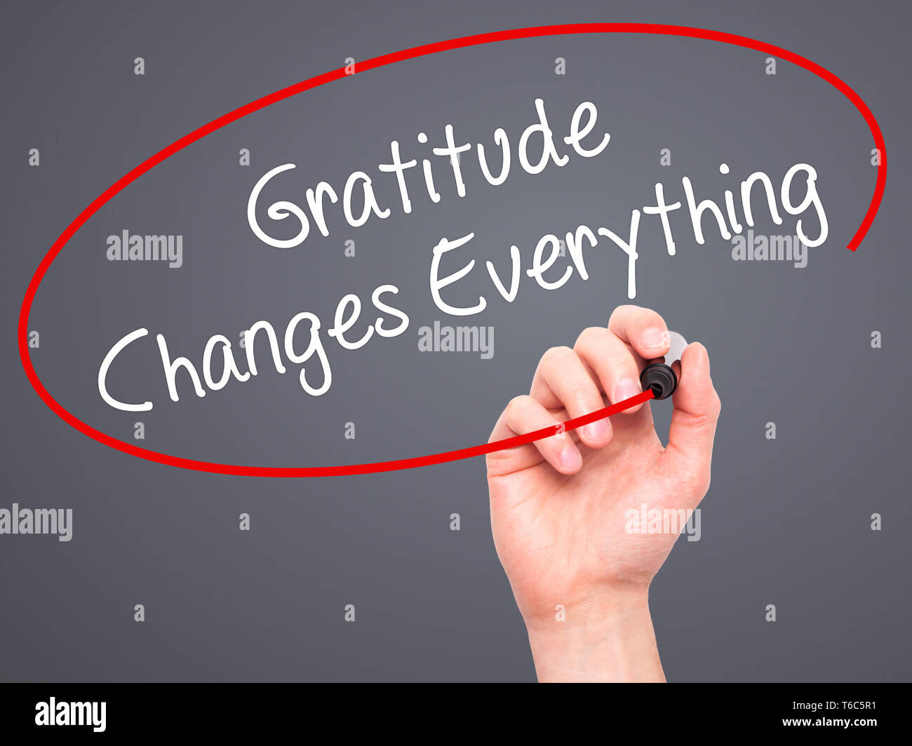 Man Hand writing Gratitude Changes Everything with black marker on visual screen Stock Photo