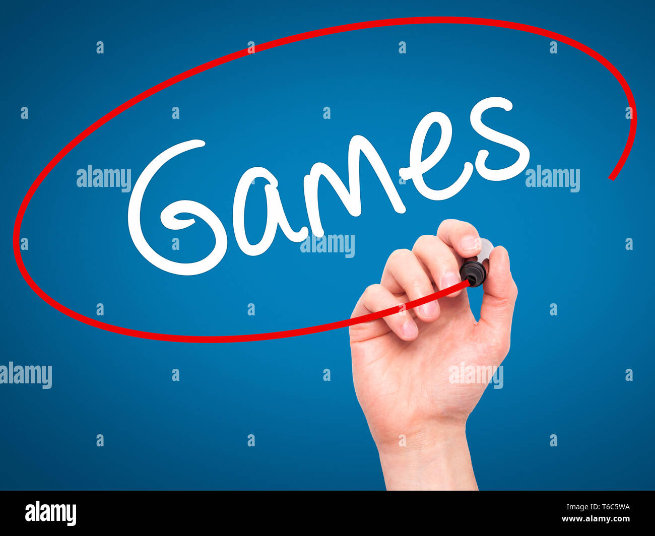 Man Hand writing Games with black marker on visual screen Stock Photo