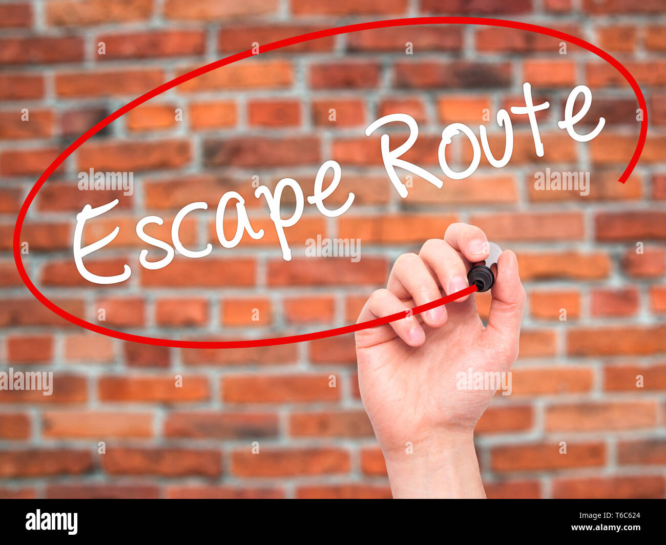 Man Hand writing Escape Route with black marker on visual screen Stock Photo