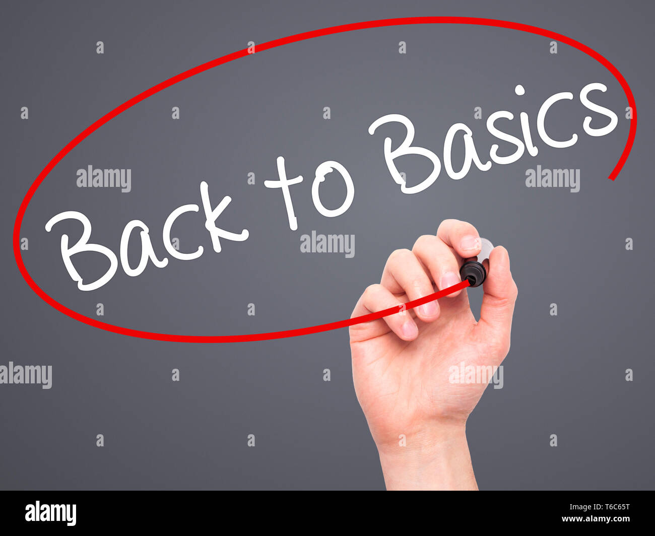 Man Hand writing Back to Basics with black marker on visual screen Stock Photo