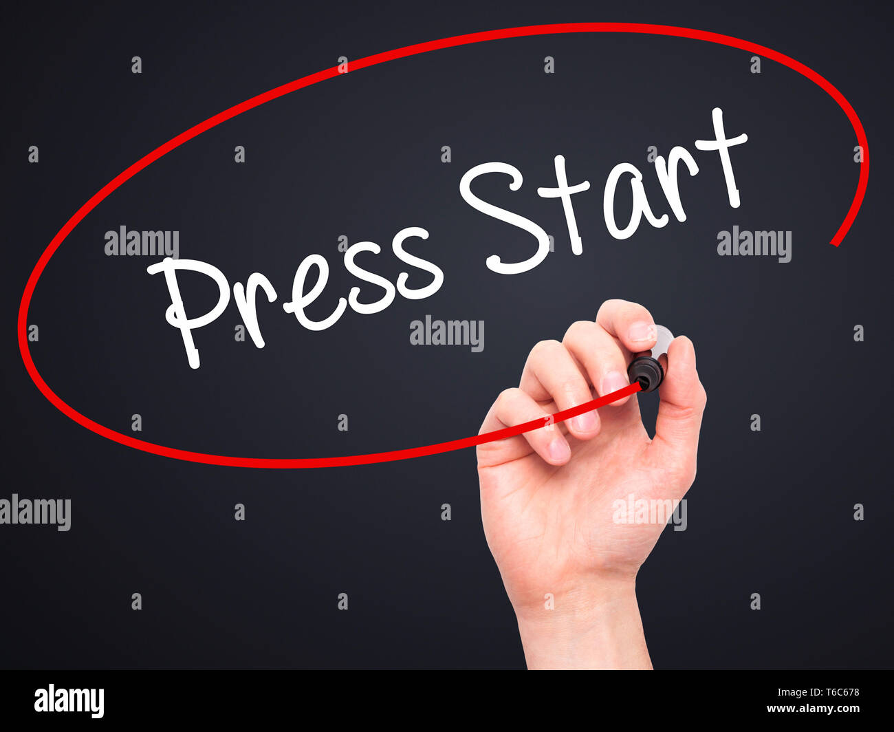 Man Hand writing Press Start with black marker on visual screen Stock Photo